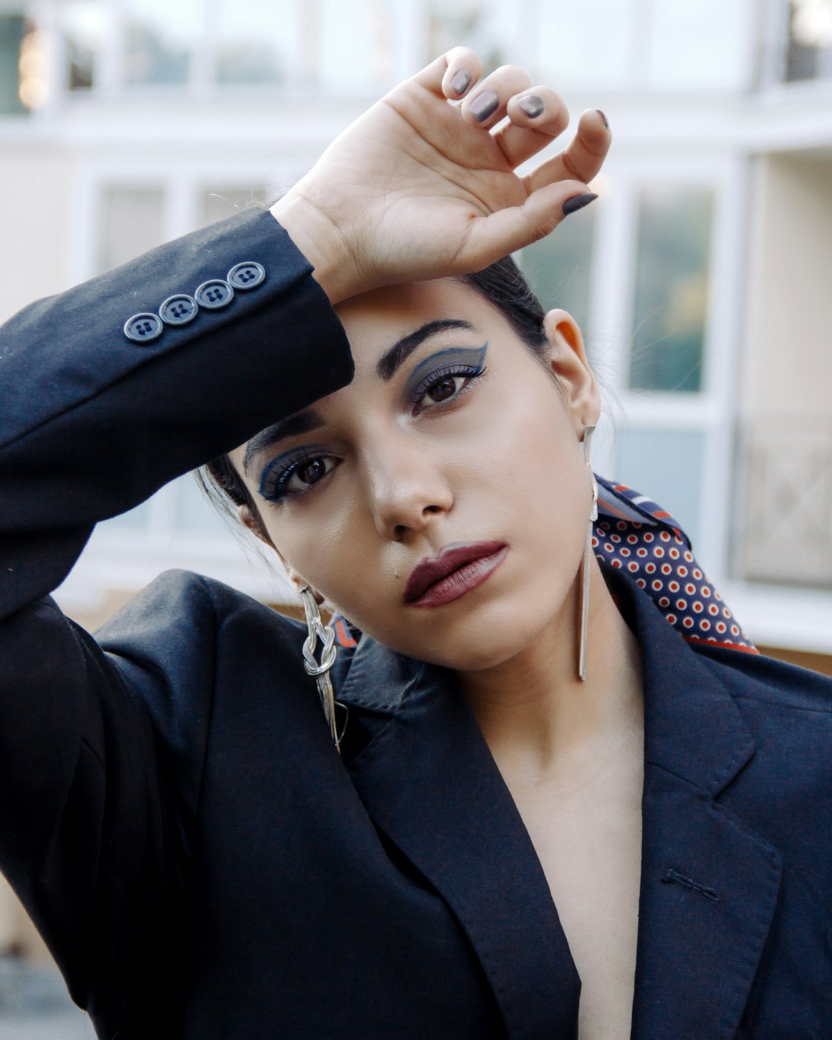 A salon owner in a blazer, looking straight at the camera